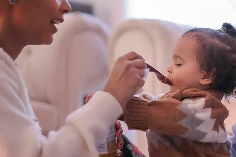 Baby being fed with spoon